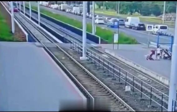 Cyclist Stumbled And Fell Right Under A Moving Tram