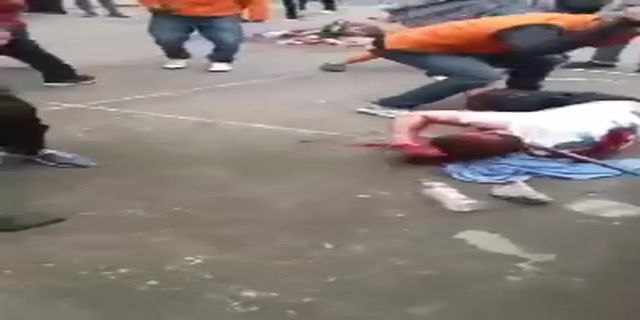 A Crowd Of Men Kill A Guy With A Metal Rod And Pierce Him With A Huge Knife