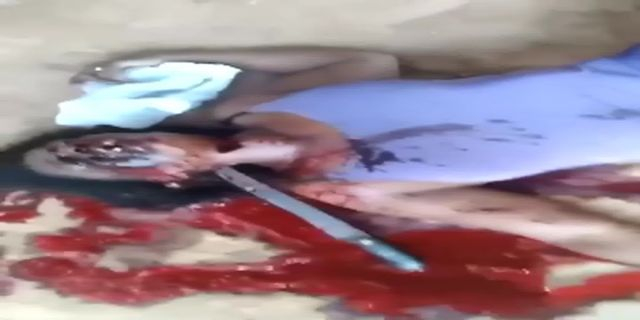 The Body Of A Woman With Her Throat Cut And A Huge Knife Stuck In Her Neck