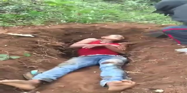 A Dude Lying In A Pit Is Killed By Blows To The Neck With A Machete