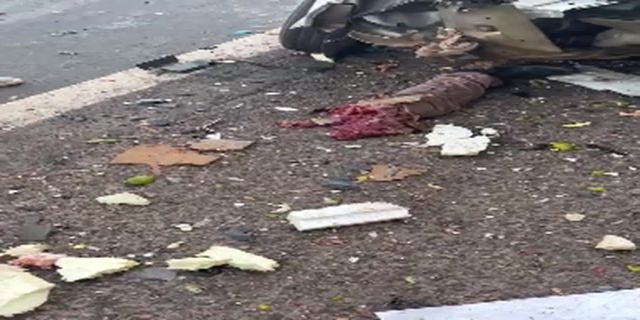 A Mutilated Car And The Driver's Body On The Road