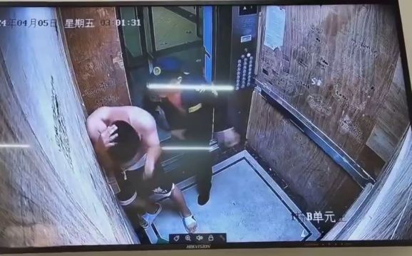 A Policeman Beats Up A Man In An Elevator