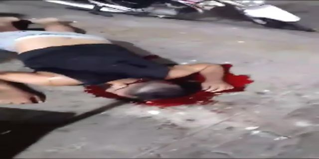 The Dead Motorcyclist Lies Face Down In A Pool Of His Own Blood