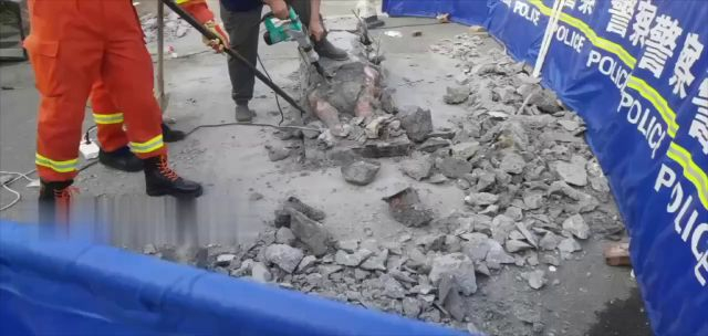 Workers Remove The Body From The Congealed Concrete
