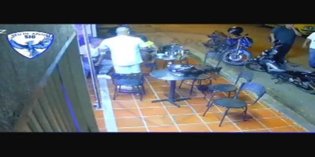 The Moment Of The Murder Of A Former Policeman At A Bar Table. Colombia