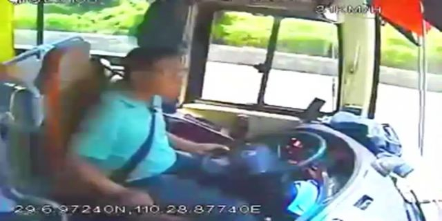 The Tour Bus Guide Kicks The Driver While Driving