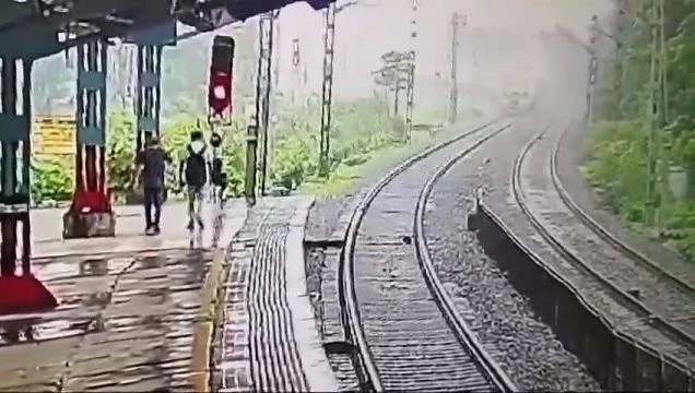 Father And Son Lay Down On The Tracks In Front Of An Approaching Train At Bhayandar Station. India