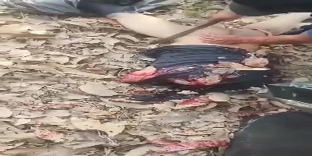 Several Butchers Dismember The Body Of A Decapitated Man