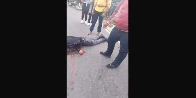 Gapers Watch As A Policeman Convulses And Dies On The Road