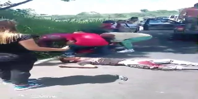 A Man With Both Broken Legs Is Waiting For Help Lying On The Road